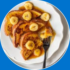 “French toast topped with bananas and caramel sauce.”