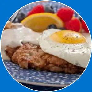 “Country fried steak served with eggs and sides.”