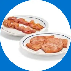 Crispy bacon strips and savory sausage links served as classic breakfast sides.