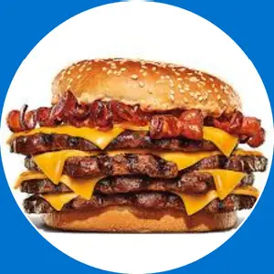 “Tall stacked burger with multiple patties and toppings.”