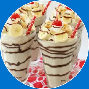 “Banana split milkshake with whipped cream, chocolate, and cherry on top.”