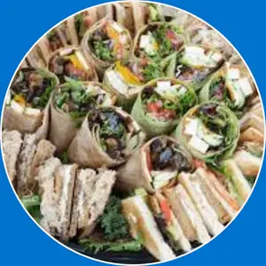 : “Sandwich and wrap platter featuring a variety of fresh sandwiches and wraps with assorted fillings, perfect for sharing.”