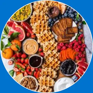 “Waffle platter featuring a golden, crispy waffle served with syrup, butter, and breakfast sides.”