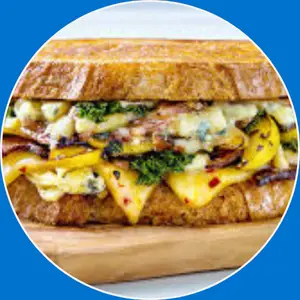 “Grilled sandwich with bacon and melted cheddar cheese.”