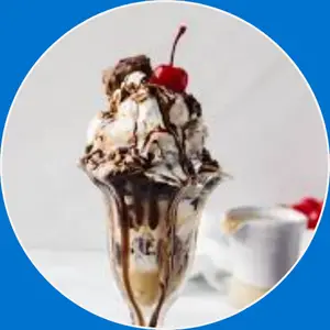 “Ice cream sundae topped with whipped cream, chocolate sauce, and classic sweet garnishes.”