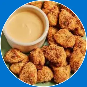 “Chicken nuggets that are crispy on the outside and tender on the inside, served as a kid-friendly meal.”