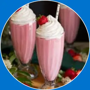 “A creamy strawberry milkshake served in a tall glass with whipped cream.”