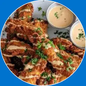 “Chicken tenders tray featuring crispy, golden chicken strips served with dipping sauces and sides for sharing.”