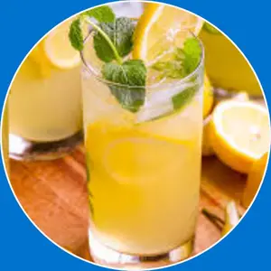 “Glass of fresh lemonade with ice cubes and a lemon slice.”