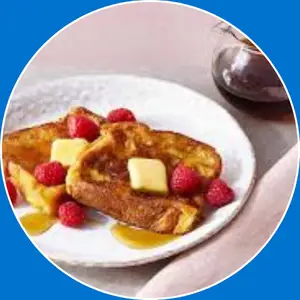 “Golden French toast served with syrup.”