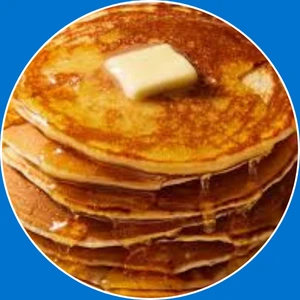 Fluffy pancakes served with syrup