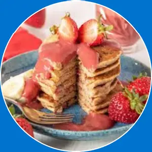 “Pancakes topped with strawberries and bananas.”